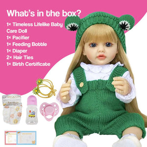 Real-feel baby doll with blonde hair, green outfit, and care accessories including pacifier, feeding bottle, diaper, and birth certificate.