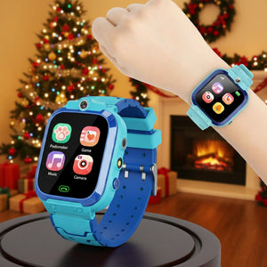Kids multi-purpose smartwatch in blue with colorful app icons on screen, displayed on wrist with Christmas tree and decorations in background