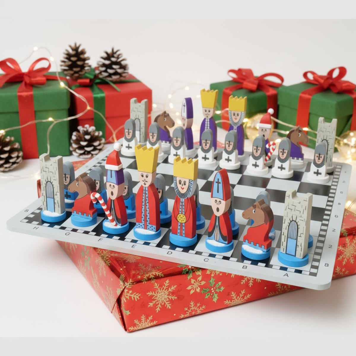Educational wooden cartoon chess set on a board with Christmas gift boxes and pinecones in background