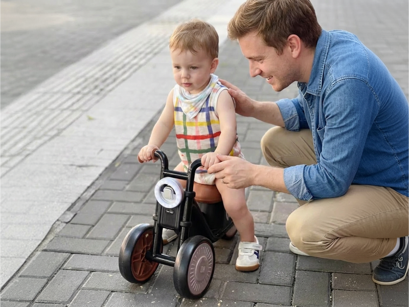 Toddler on the Tiny Biker with dad